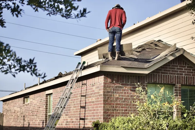 Professional roofer working on a residential roof in Hoover